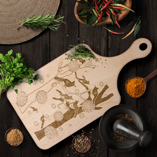 Cardinals In The Winter Snow Paddle Cutting Board
